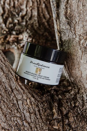 Jar of MaoRadiance moisturizing face cream on a tree branch