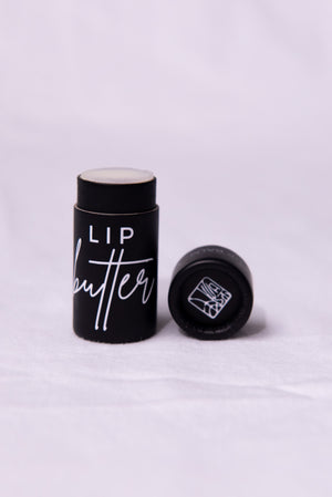 Lip butter container with black lid on a white background