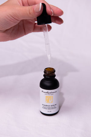 Hand holding a dropper over a bottle labeled 'MaoRadiance' on a white background