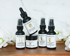 Collection of skincare products from Mao Radiance on a wooden surface with flowers in the background.