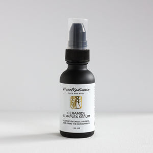 Bottle of Ceramide Complex Serum with black cap on a white background
