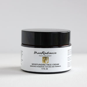 Jar of moisturizing face cream with black lid on a white background