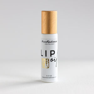 Lip oil bottle with wooden cap on a light gray background
