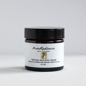 Jar of peptide rich eye cream with black lid on a white background