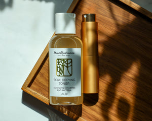Two skincare products on a wooden tray with a light background