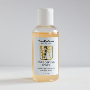 Bottle of pore defying toner with a label on a white background
